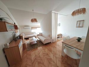 a living room with a couch and a table at Queen's Apartment Ohrid in Ohrid +40 photos