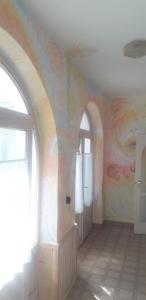 a room with a rainbow mural on the wall at Közös Nevező Vendegház in Keszthely