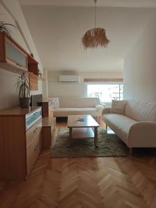 a living room with a couch and a table at Queen's Apartment Ohrid in Ohrid