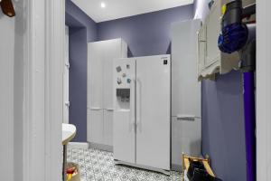 a kitchen with a white refrigerator and purple walls at Hermitage Suite - Stylish Shared Accommodation in Dundee +18 photos