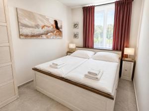 a bedroom with a large white bed in a room at Aparthotel Olympland in Trutnov