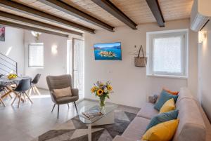 a living room with a couch and a table at Casa Quadrifoglio - Ticino in Intra