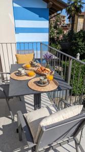a table with food and oranges on a balcony at Casa Quadrifoglio - Ticino in Intra