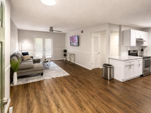 a living room with a couch and a kitchen at Maple n Main Hoover Modern 2BR Escape 2E in Hoover +19 photos