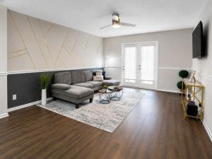 a living room with a couch and a table at Maple n Main Hoover Modern 2BR Escape 2E in Hoover
