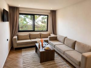 a living room with a couch and a table at Oceana Mazagan Suites Hôtel in El Jadida