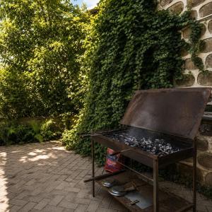 a barbecue grill sitting in front of a wall at Zanger Hotel in Goris