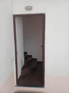 a hallway with a mirror and stairs in a room at Scoglietti Loft in Ventimiglia