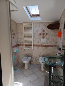 a bathroom with a toilet and a sink at Scoglietti Loft in Ventimiglia