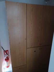 a bedroom with two wooden cabinets and a fire extinguisher at Scoglietti Loft in Ventimiglia