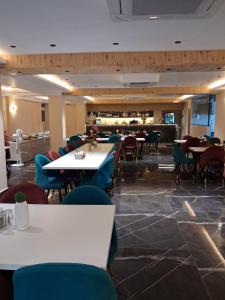 a dining room with tables and chairs and a restaurant at Hotel Silver Oak in Dehradun