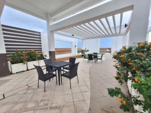 a patio with a table and chairs and flowers at Roomy 1BR Balcony-40sqm-4px-PET-Parking-MOA,PICC,WTC,CCP in Manila