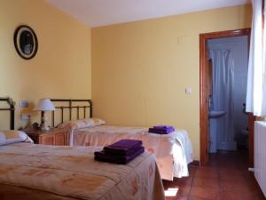 a hotel room with two beds with towels on them at Casa rural Casa Camilo in Agüero