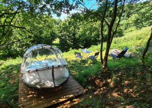 a tent sitting on a wooden table in a field at La Noisette Basque - Nuits au verger in Saint-Pée-sur-Nivelle