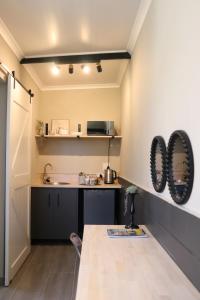 a small kitchen with a counter and a sink at Favour House in Bethlehem