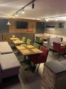 a restaurant with tables and chairs in a room at ЭКО готель ,,Челентано ,, in Slavuta