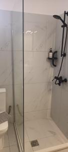 a shower with a glass door in a bathroom at Rosilion Studios & Apartments in Katelios +41 photos