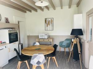 a kitchen with a table and chairs in a room at La morvandelle in Limanton