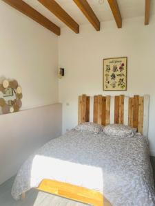 a bedroom with a bed with a wooden headboard at La morvandelle in Limanton +1 photo