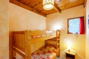 a bedroom with two bunk beds and a chandelier at Le Chêne - La Fontinelle in Bessas +27 photos