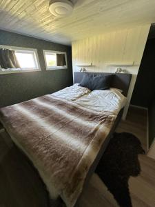 a bedroom with a large bed with a blanket on it at Parkgatan in Vemdalen
