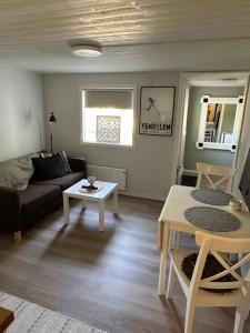 a living room with a couch and a table at Parkgatan in Vemdalen