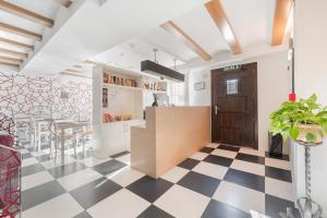 a kitchen with a black and white checkered floor at OTTIUM Albanuracín in Albarracín