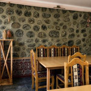 a dining room with a wooden table and chairs at Zanger Hotel in Goris