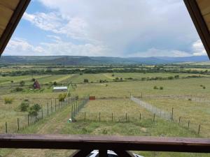 a view of a field from a window at Asureti Horizon Cottage in Asuretʼi