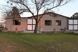 a house with a tree in front of it at Favour House in Bethlehem +18 photos