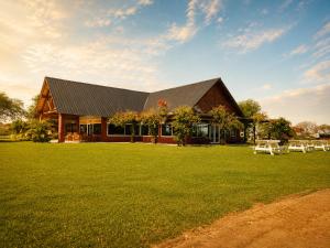 a house with a large lawn in front of it at Rincon del Dorado Lodge in Goya