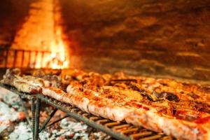 a row of pizzas cooking in an oven at Rincon del Dorado Lodge in Goya