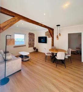a living room with a table and a couch at Ferienwohnungen Soldanski in Loddin