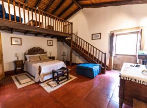a bedroom with a large bed and a staircase at Casa De Anquiao - Turismo de Habitação in Ponte de Lima +53 photos