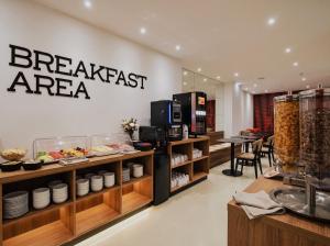 a restaurant with a breakfast area with food on display at Zyra Hotel St Julians - Adults only in St. Julianʼs