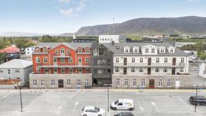 a large building with cars parked in a parking lot at Amtmann Residence by Heimaleiga in Selfoss