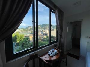 a room with a table and a large window at Anh Duong in Lục Yên