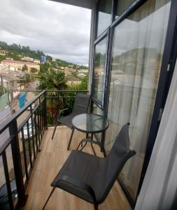 a balcony with a table and chairs and a view at Rusa in P'eria
