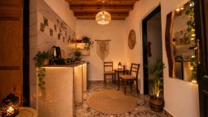 a kitchen with a refrigerator and a table in a room at Cozy Dahab Studio with Private Courtyard in Dahab