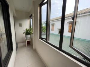a hallway with windows and a swimming pool at Anh Duong in Lục Yên
