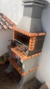a brick oven sitting next to a wall at Monte do Vale in Casa Branca