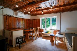 a room with a kitchen and a dining room with a table at Mama Chata a Mama Spa Beskydy in Bílá +27 photos