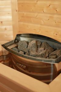 a container of rocks sitting on a table at Casa Roua Munților in Dămuc