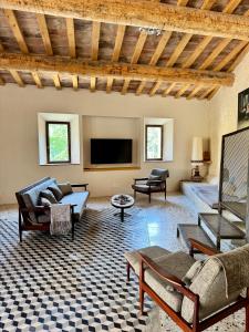 a living room with furniture and a flat screen tv at Domaine de Ribaute in Lieuran-lès-Béziers