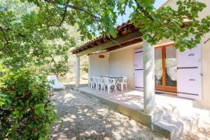 a patio of a house with a table and chairs at Le Chêne - La Fontinelle in Bessas