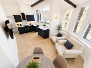 a living room with two chairs and a table at Castle Chambers Serviced Apartments in Lancaster