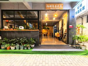 an entrance to a restaurant with potted plants at 芮嘉民宿 阳朔西街店 in Yangshuo