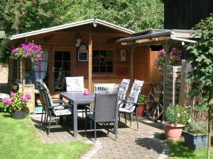a table and chairs in front of a house at Gerkenhof in Olsberg