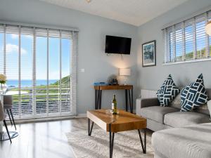 a living room with a couch and a table at Dunmore East Ocean View Suite in Dunmore East +16 photos