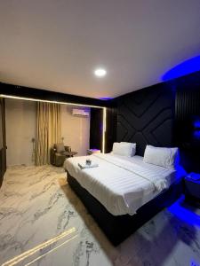 a large bedroom with a large bed in a room at Kim Royal Hotel and Suites in Festac Town